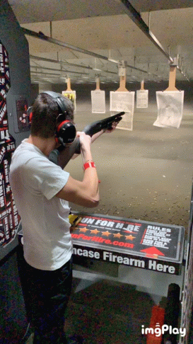 a man with headphones is shooting at some targets
