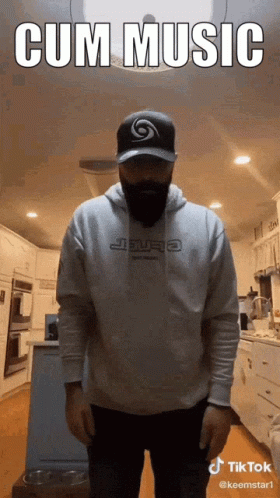man standing in a commercial kitchen wearing a hoodie