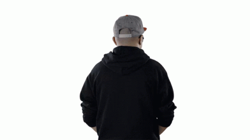 a person with a hat standing on his hoodie