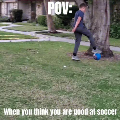 a man playing with a orange ball in the grass