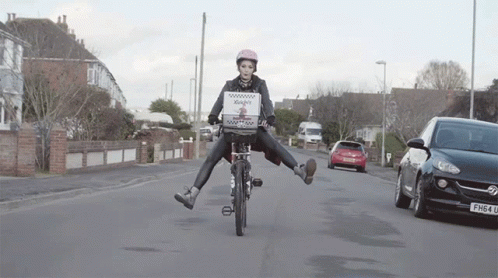a person riding a bike over an obstacle