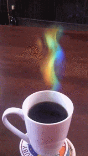 the cup has soing bright on it in front of a rainbow