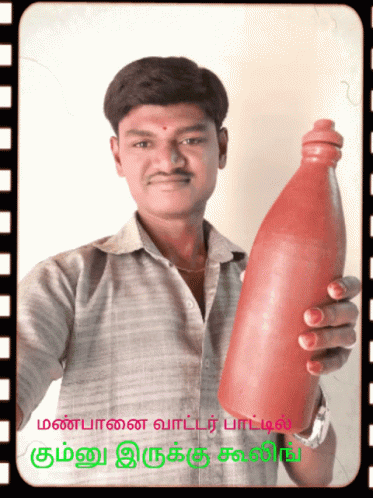 man holding an empty purple bottle in front of a po
