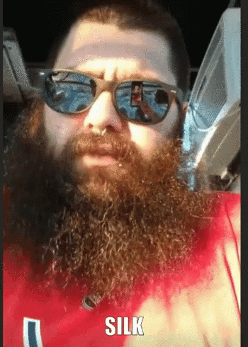a man with a beard and sunglasses looks surprised