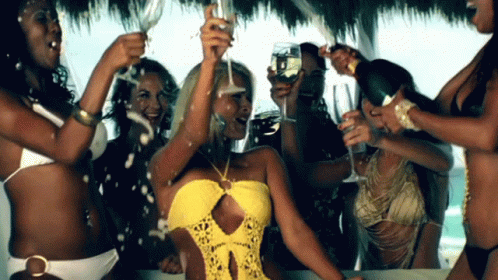 several women in bikinis toasting with champagne flutes