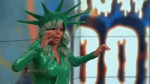 a statue of liberty on television in a green costume