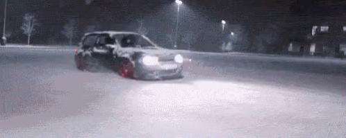 a car driving on the road in the middle of snow
