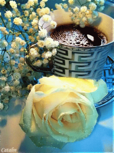 a cup of tea and some flowers with a yellow background