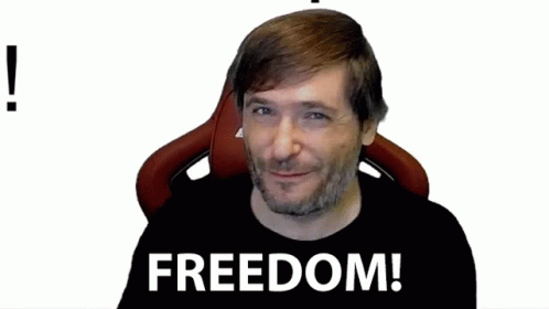 a man sitting in a chair with a black shirt with the words freedom