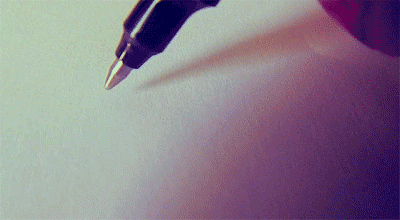 a black fountain pen laying on top of a piece of paper