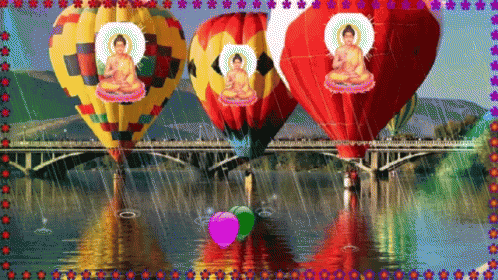three large balloons floating over a river filled with water