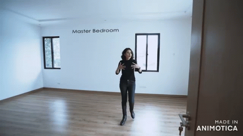 a woman is taking a self portrait in an empty room