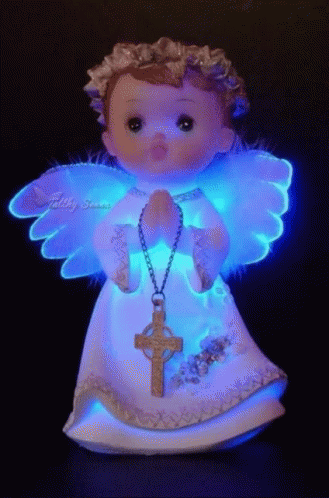 a glowing statue with an angel holding a cross