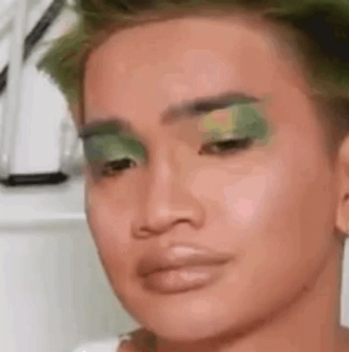 a close up of a person with green makeup