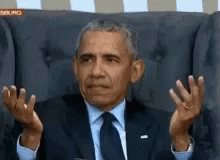 obama with blue hands sitting in a chair