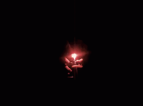 a person holding a light up in the dark