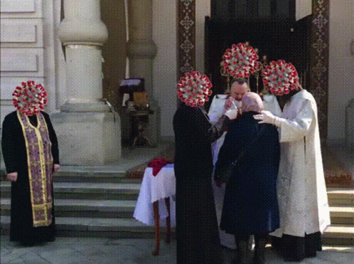 a group of priests standing at the alter in front of a building
