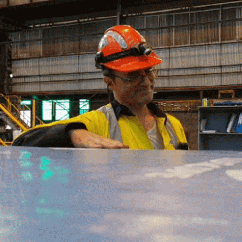 a worker in hardhat with paint on his face