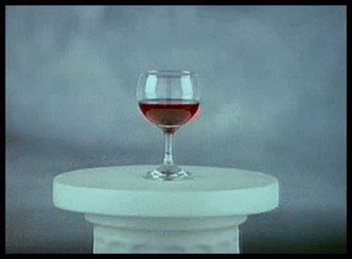 an artistic picture with a glass of wine on a pedestal