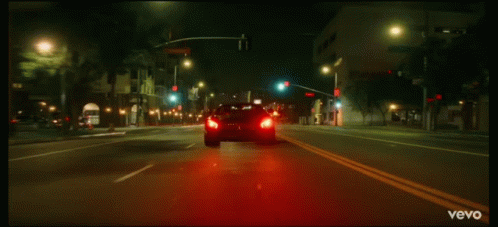 there is a car that is driving in the night