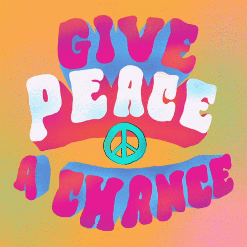 a sign with a peace sign on it saying give peace a chance