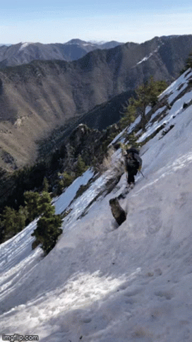 a person is hiking on a snowy mountain