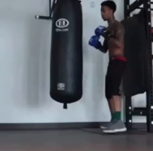 an animated man with a punching bag on the gym floor