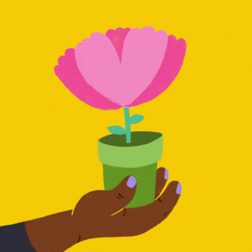 someone holding a plastic flower in a small cup
