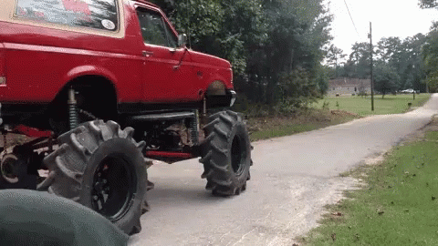 monster truck going down a dirt path on two large wheels