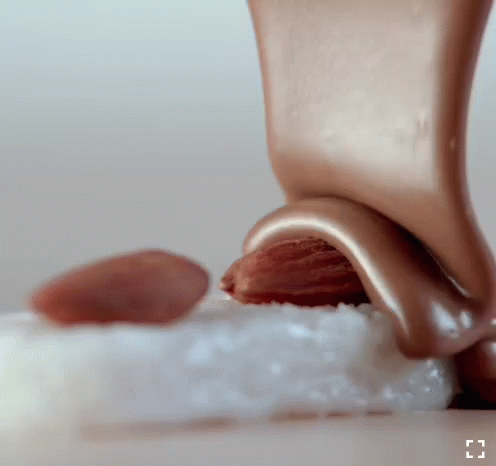 the tip of a toy roller, with small powdered pieces of sugar beside it