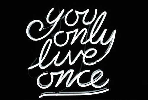 the words you only live once are in neon lights