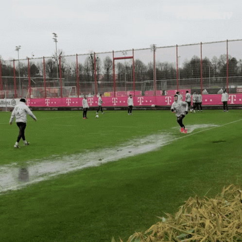 there are many soccer players playing in the rain
