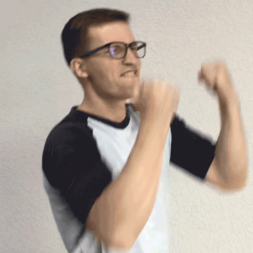 a man with glasses is making a gesture