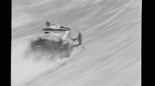 the old race car is riding down the snowy hill