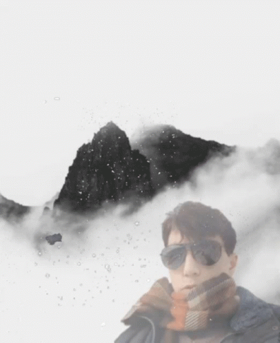 a person standing in front of some mountain covered in snow
