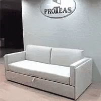 a white couch and two tables in an office