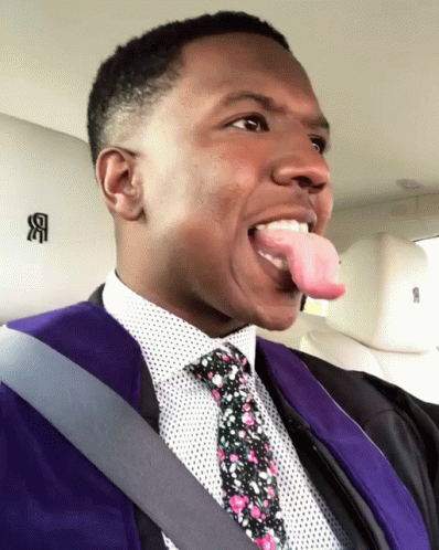 a black man in a suit and tie with purple hair