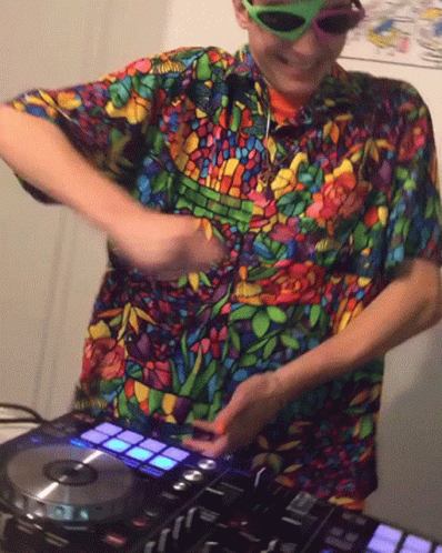 man in the process of mixing an electronic music set