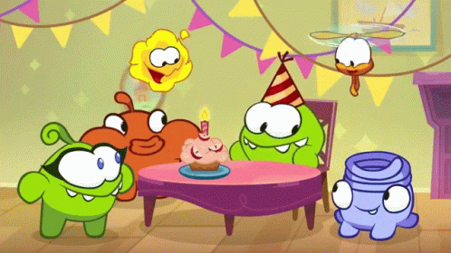 a group of cut - out animals sitting around a purple cake