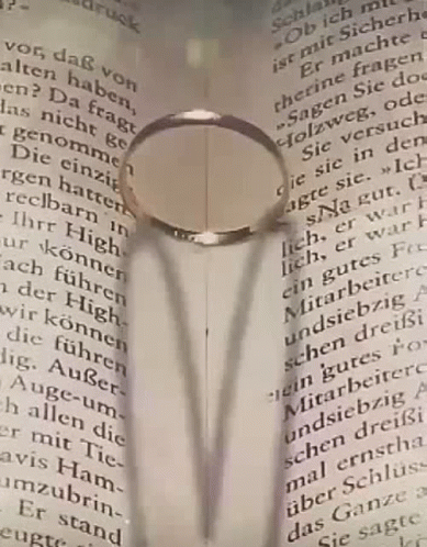 an open book with a magnifying glass over it