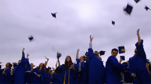 graduates toss their caps in the air on graduation day