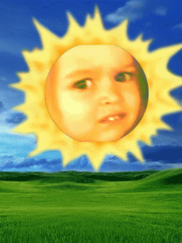 a child has a sun over their face on the grass