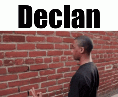 a man is in front of a wall that says declan