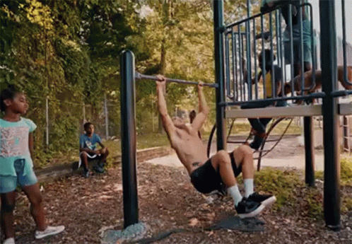 a man hanging upside down from a metal structure