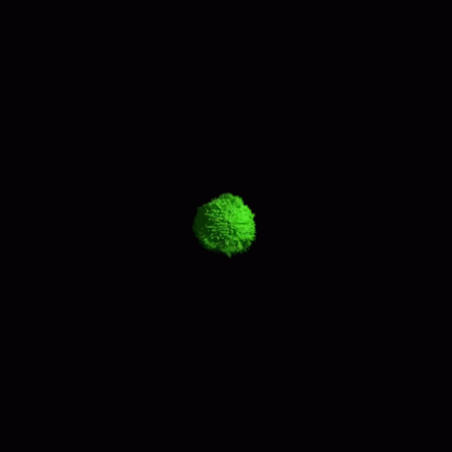 a ball of green glow is illuminated in the dark