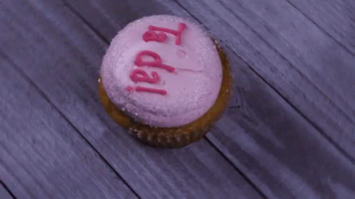 there is a birthday cupcake with frosting on it