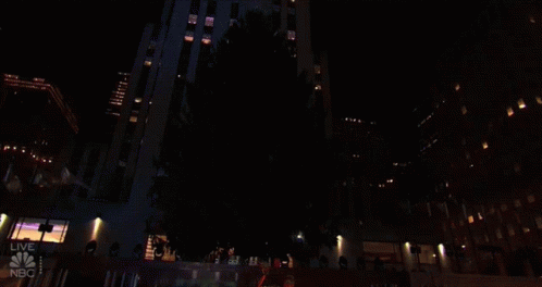 a very tall building at night with all lights on