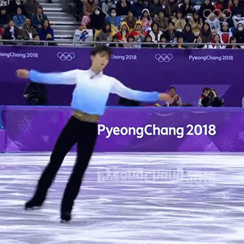 an olympic figure performing on the ice at an event