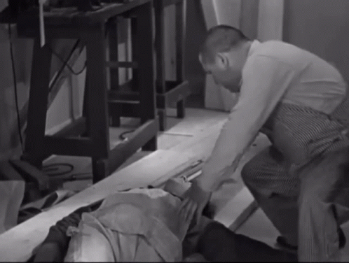 two men bending down to inspect furniture