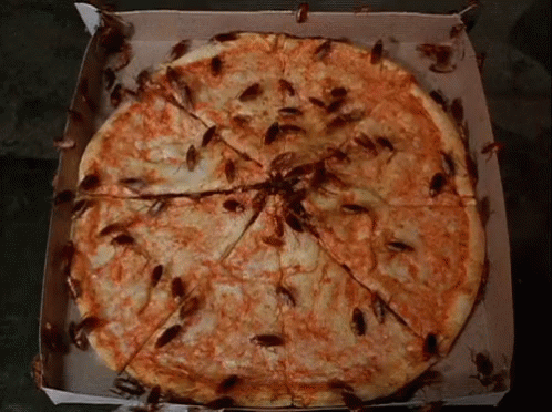 a large box is loaded with a pizza covered in blue dye
